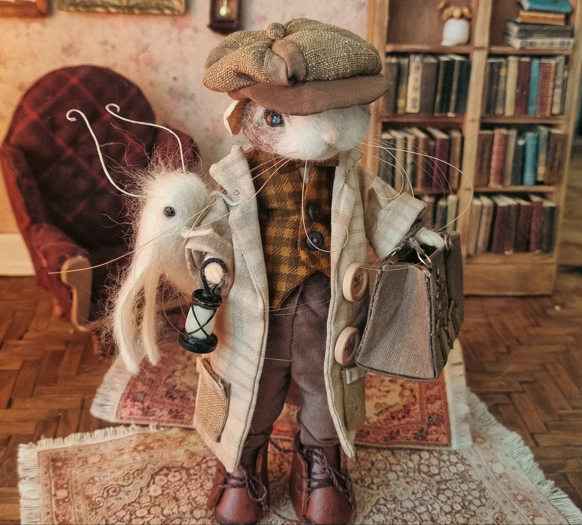 A mouse dressed as a gentleman traveler, wearing a tweed cap, beige coat, brown vest, and brown boots, holding a small lantern and a bag, posed in a vintage-style room with a bookshelf and armchair.